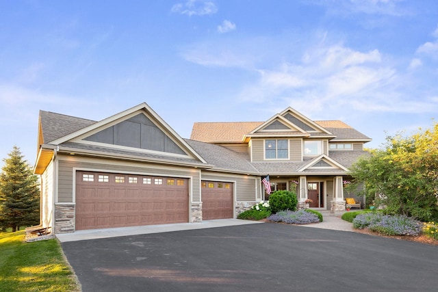 1899 White Oak Dr, Chaska, MN 55318 - craftsman house featuring stone siding, covered porch, asphalt driveway, and an attached garage
