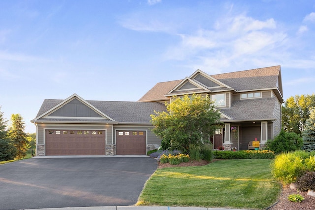 1899 White Oak Dr, Chaska, MN 55318 - craftsman-style home featuring asphalt driveway, an attached garage, a front yard, stone siding, and a shingled roof