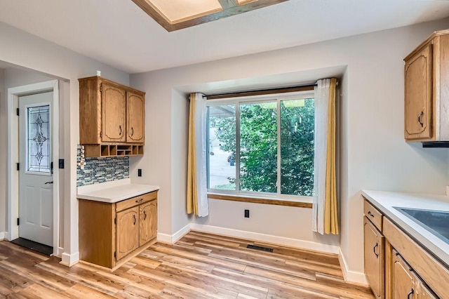 7236 Clear Rdg, Centerville, MN 55038 - kitchen featuring light wood finished floors, light countertops, and decorative backsplash