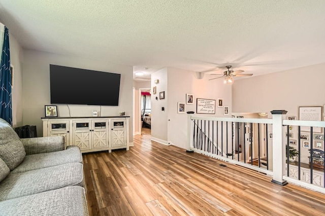 7236 Clear Rdg, Centerville, MN 55038 - living area featuring wood finished floors, ceiling fan, and a textured ceiling