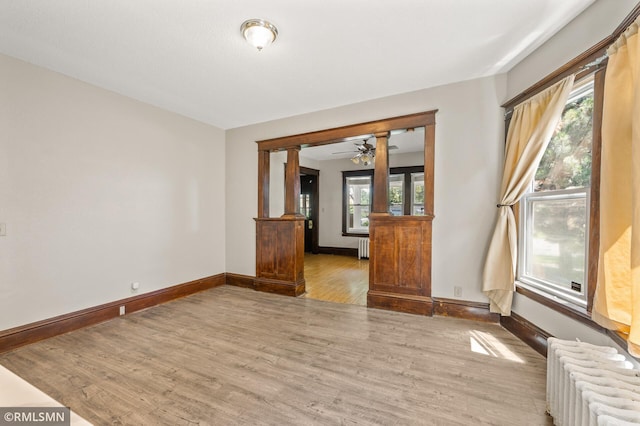 727 Virginia St, Saint Paul, MN 55103 - spare room with radiator, wood finished floors, healthy amount of natural light, and a ceiling fan