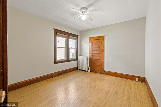727 Virginia St, Saint Paul, MN 55103 - spare room featuring radiator, a ceiling fan, and hardwood / wood-style floors