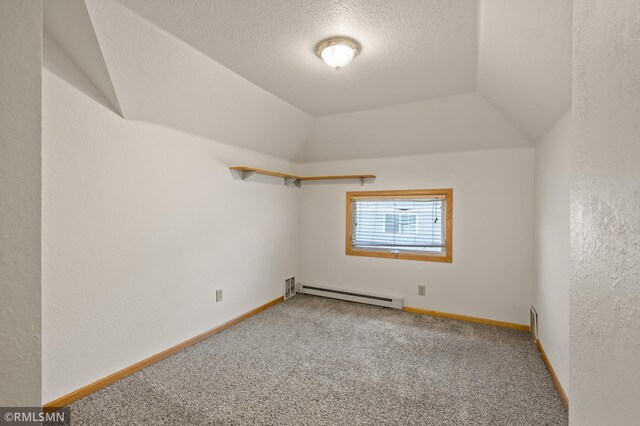 727 Virginia St, Saint Paul, MN 55103 - empty room featuring a baseboard heating unit, carpet flooring, and a textured ceiling