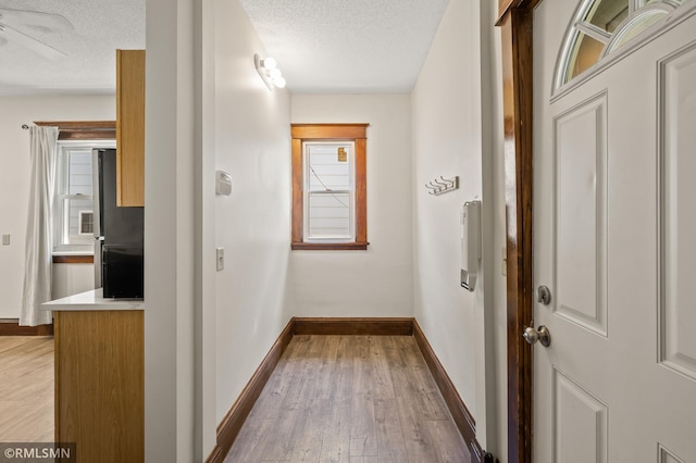 727 Virginia St, Saint Paul, MN 55103 - corridor with a textured ceiling and wood finished floors