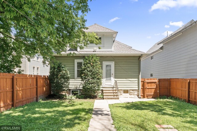 727 Virginia St, Saint Paul, MN 55103 - rear view of house featuring entry steps, a fenced backyard, and roof with shingles