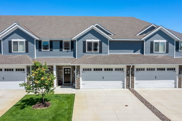 12910 Brenly Way, Rogers, MN 55374 - townhome / multi-family property with driveway, a front lawn, stone siding, an attached garage, and a shingled roof