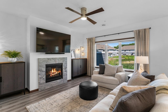 12910 Brenly Way, Rogers, MN 55374 - living area with wood finished floors, ceiling fan, and a premium fireplace