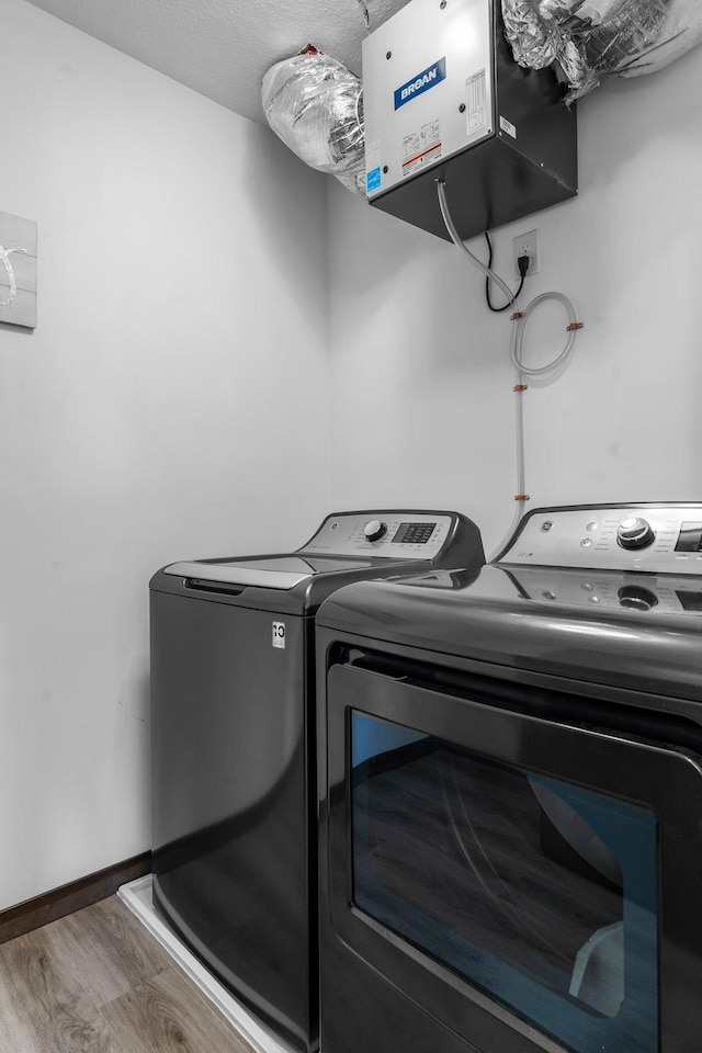 12910 Brenly Way, Rogers, MN 55374 - laundry area with wood finished floors, independent washer and dryer, and a heating unit