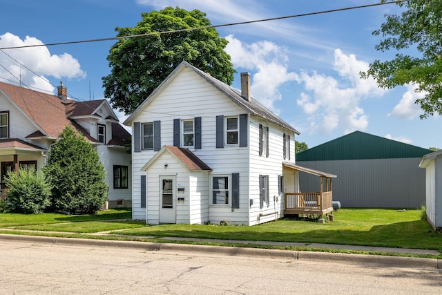 213 Caledonia St, Caledonia, MN 55921 - view of front of house with a chimney and a front yard