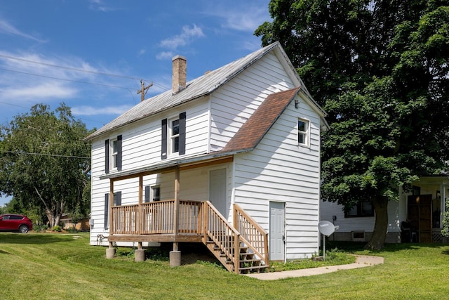 213 Caledonia St, Caledonia, MN 55921 - rear view of property featuring a chimney, a lawn, and a shingled roof