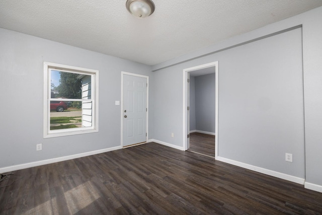 213 Caledonia St, Caledonia, MN 55921 - unfurnished room with dark wood-style floors and a textured ceiling