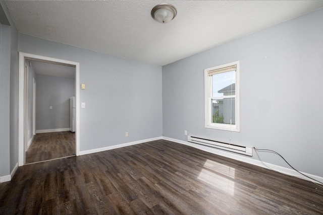 213 Caledonia St, Caledonia, MN 55921 - unfurnished room featuring baseboard heating and dark wood-style flooring