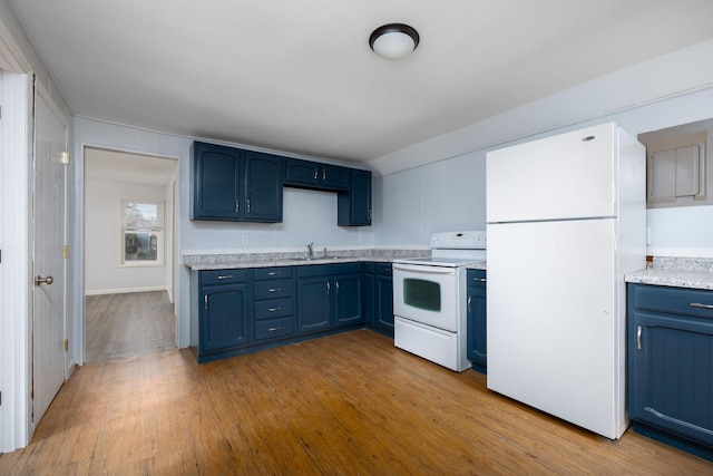 213 Caledonia St, Caledonia, MN 55921 - kitchen featuring white appliances, blue cabinetry, light countertops, and wood finished floors