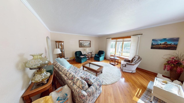 1314 Dunham St, Albert Lea, MN 56007 - living area with arched walkways, ornamental molding, wood finished floors, and a textured ceiling