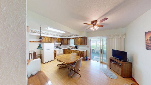 1314 Dunham St, Albert Lea, MN 56007 - kitchen featuring white appliances, light wood-style floors, light countertops, ceiling fan, and under cabinet range hood