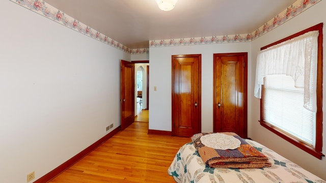 1314 Dunham St, Albert Lea, MN 56007 - bedroom with light wood-type flooring and two closets