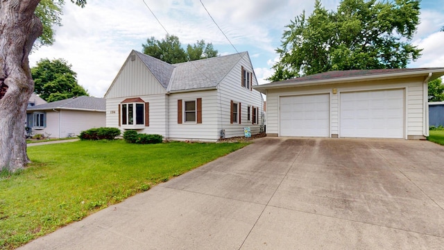 1314 Dunham St, Albert Lea, MN 56007 - view of front of property featuring an outdoor structure, a front lawn, a detached garage, and board and batten siding