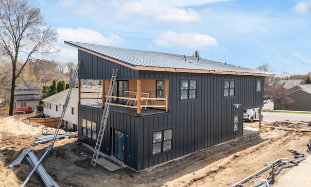 7577 138th St W, Apple Valley, MN 55124 - back of property featuring a balcony, board and batten siding, and a metal roof