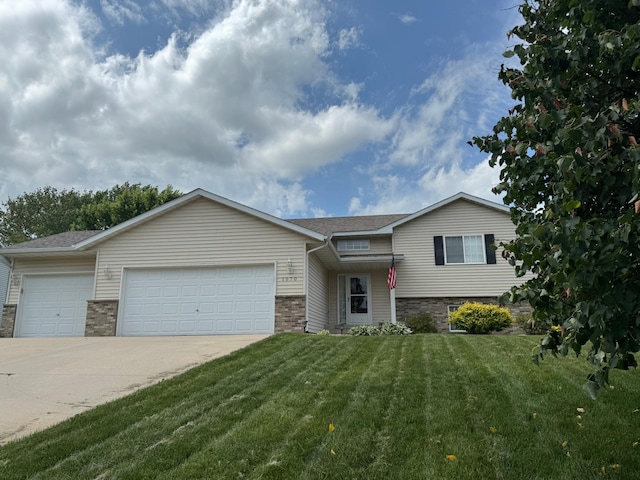 1070 20th St NE, Owatonna, MN 55060 - tri-level home with a garage, driveway, a front lawn, and a shingled roof