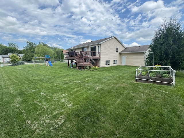 1070 20th St NE, Owatonna, MN 55060 - rear view of property with a garden, a wooden deck, a playground, and stairway