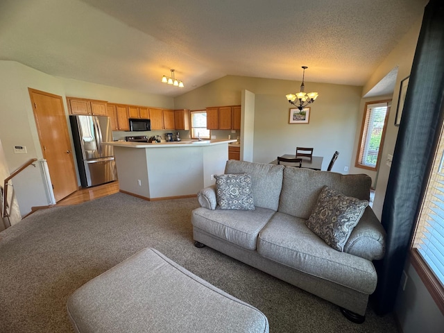 1070 20th St NE, Owatonna, MN 55060 - living area featuring a chandelier, lofted ceiling, and light colored carpet