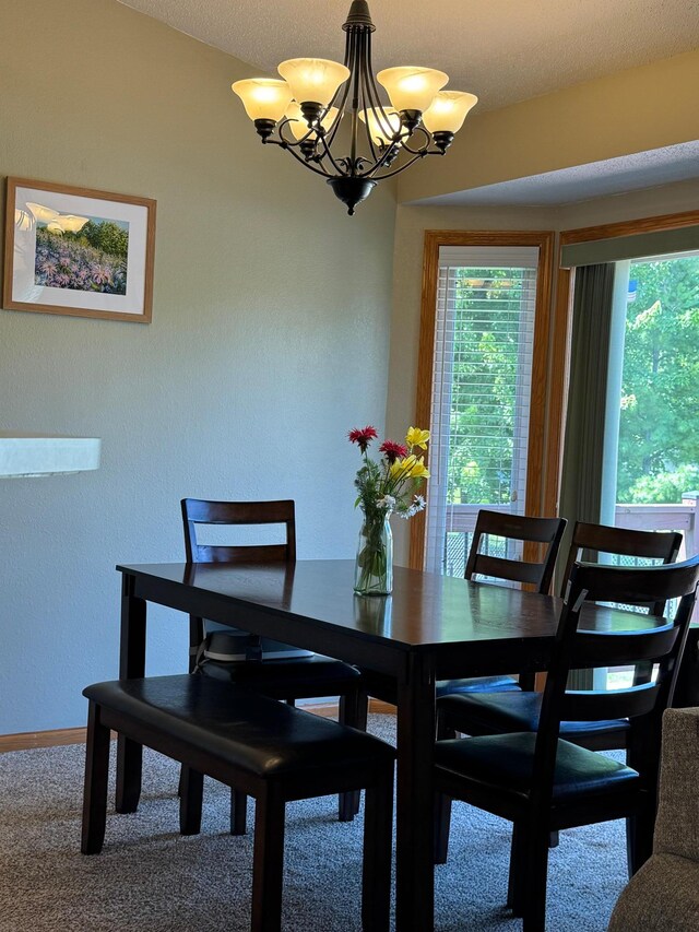 1070 20th St NE, Owatonna, MN 55060 - carpeted dining area featuring a chandelier and baseboards