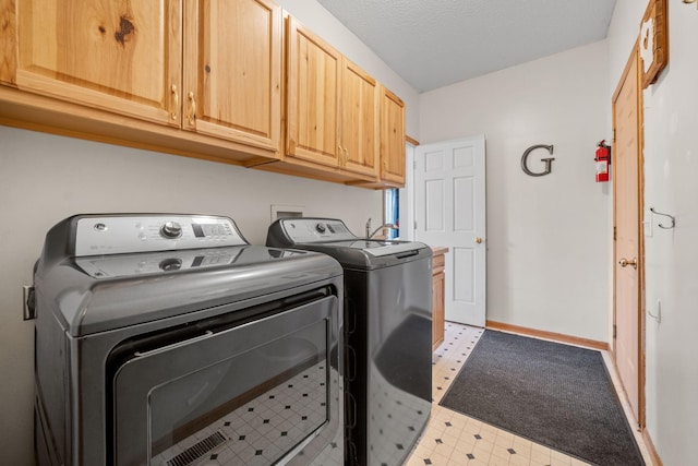 2418 Thrush St, Shakopee, MN 55379 - washroom featuring cabinet space, separate washer and dryer, and light flooring