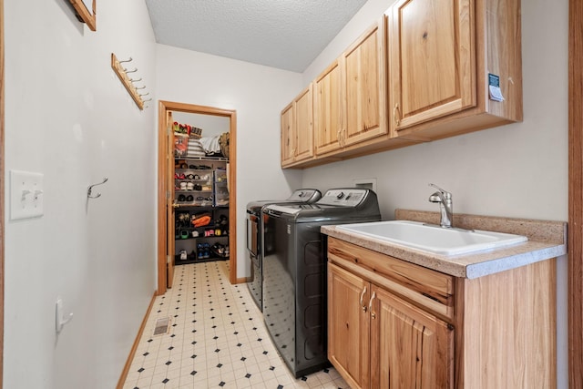 2418 Thrush St, Shakopee, MN 55379 - laundry room with independent washer and dryer, light floors, cabinet space, and a textured ceiling