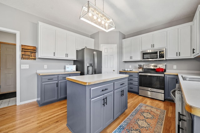2418 Thrush St, Shakopee, MN 55379 - kitchen with stainless steel appliances, gray cabinetry, and white cabinets