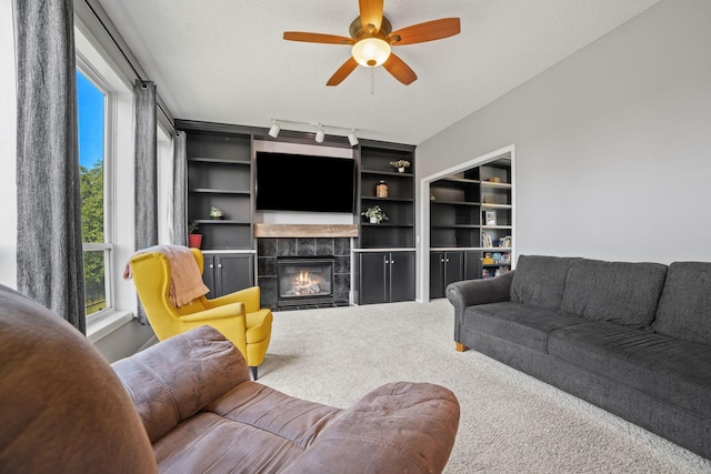 2418 Thrush St, Shakopee, MN 55379 - carpeted living room with a tiled fireplace, ceiling fan, and rail lighting