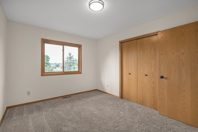 2824 92nd Cres N, Brooklyn Park, MN 55443 - unfurnished bedroom with carpet, a closet, and a textured ceiling