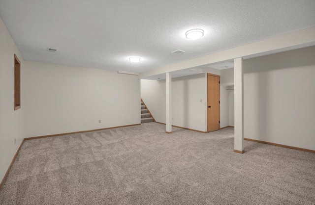 2824 92nd Cres N, Brooklyn Park, MN 55443 - finished below grade area with carpet flooring, a textured ceiling, and stairway