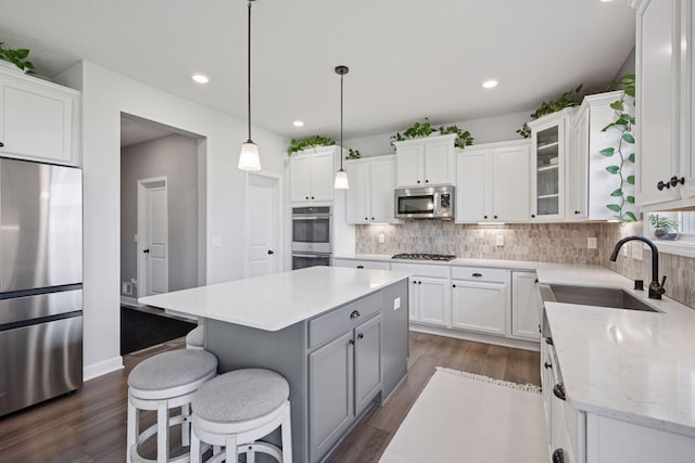 12745 39th St NE, Saint Michael, MN 55376 - kitchen with stainless steel appliances, a center island, dark wood finished floors, white cabinetry, and recessed lighting