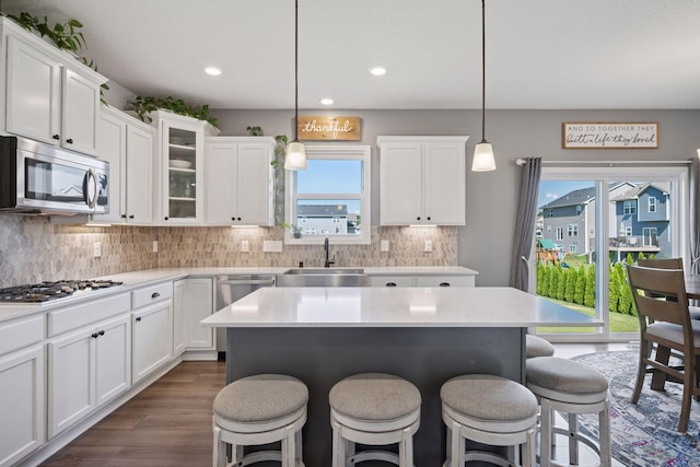 12745 39th St NE, Saint Michael, MN 55376 - kitchen with stainless steel appliances, a kitchen breakfast bar, white cabinetry, light countertops, and recessed lighting