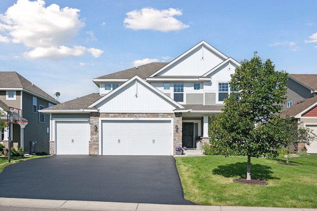 12745 39th St NE, Saint Michael, MN 55376 - craftsman house featuring asphalt driveway, an attached garage, a front yard, and stone siding
