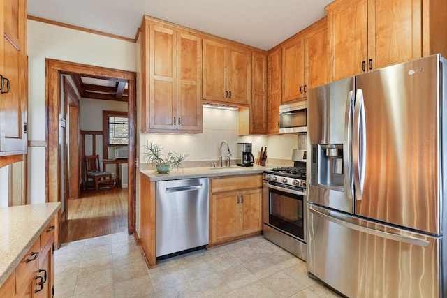 3343 Humboldt Ave S, Minneapolis, MN 55408 - kitchen featuring stainless steel appliances, light stone countertops, brown cabinets, and crown molding