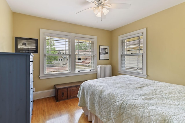 3343 Humboldt Ave S, Minneapolis, MN 55408 - bedroom featuring radiator, light wood-style floors, and ceiling fan