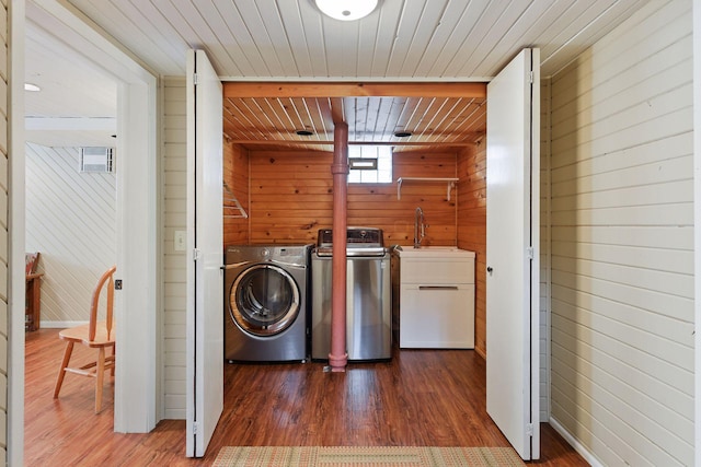 3343 Humboldt Ave S, Minneapolis, MN 55408 - washroom with washer and clothes dryer, wooden walls, dark wood-style floors, and wooden ceiling