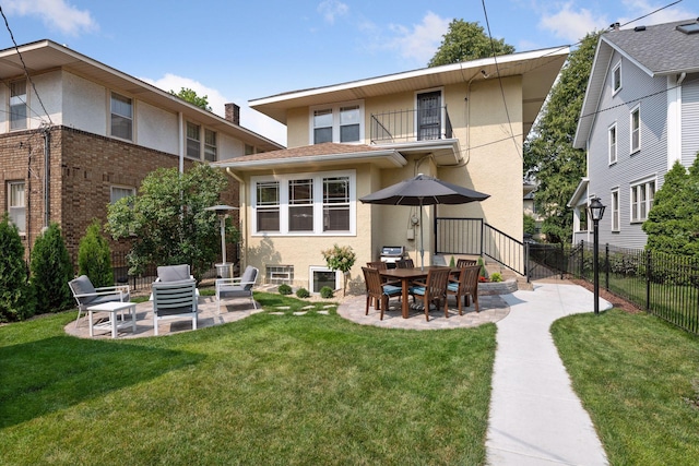 3343 Humboldt Ave S, Minneapolis, MN 55408 - rear view of house featuring stucco siding, a balcony, and a patio area