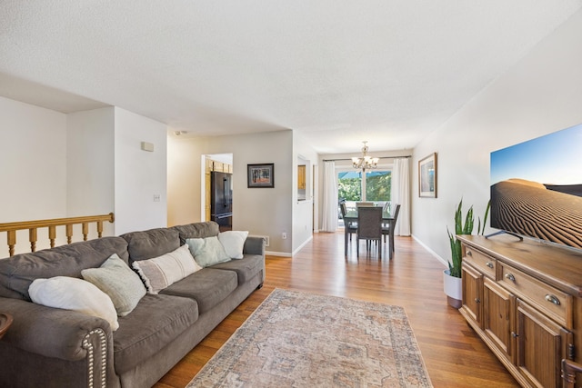 11810 191 1/2 Ave NW, Elk River, MN 55330 - living room featuring a chandelier and light wood-style flooring