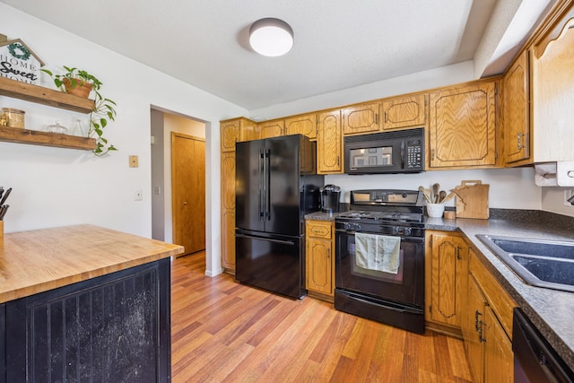 11810 191 1/2 Ave NW, Elk River, MN 55330 - kitchen with black appliances, light wood-style floors, brown cabinetry, and open shelves
