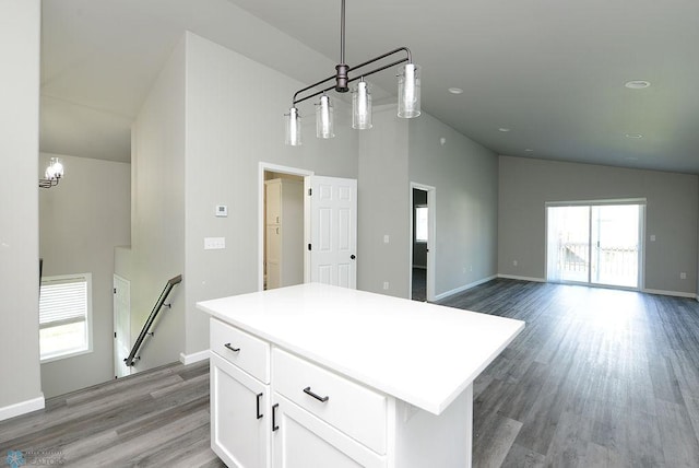 1040 Barnes Dr, West Fargo, ND 58078 - kitchen featuring white cabinets, light wood-type flooring, a center island, high vaulted ceiling, and pendant lighting