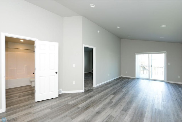 1040 Barnes Dr, West Fargo, ND 58078 - unfurnished living room with high vaulted ceiling, wood finished floors, and recessed lighting