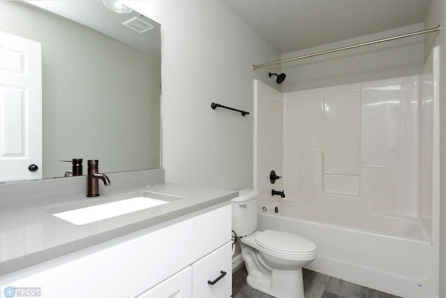 1040 Barnes Dr, West Fargo, ND 58078 - bathroom featuring vanity, shower / bathtub combination, and wood finished floors