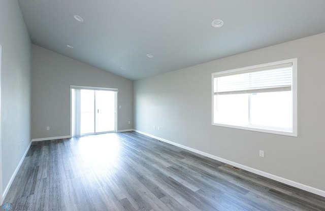 1040 Barnes Dr, West Fargo, ND 58078 - empty room featuring wood finished floors and vaulted ceiling