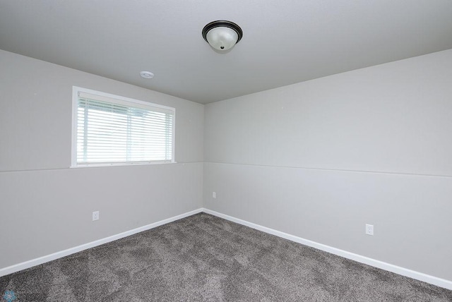 1040 Barnes Dr, West Fargo, ND 58078 - empty room featuring dark colored carpet and baseboards
