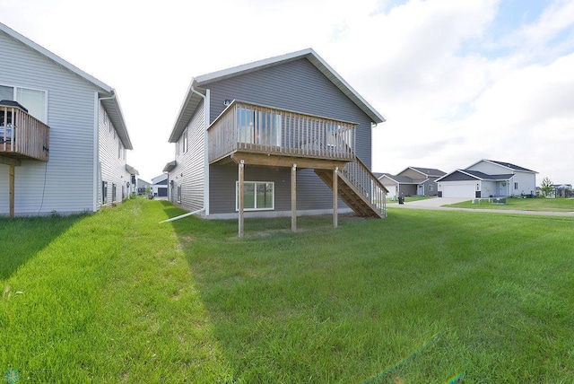 1040 Barnes Dr, West Fargo, ND 58078 - back of property featuring a lawn, a wooden deck, stairway, and a residential view