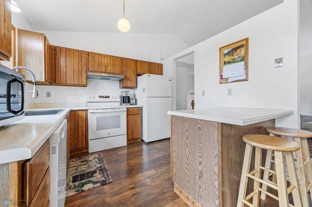 3318 Village Green Dr, Moorhead, MN 56560 - kitchen with white appliances, brown cabinets, under cabinet range hood, lofted ceiling, and a peninsula