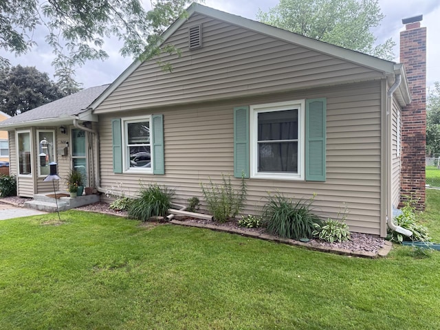 7420 Columbus Ave, Richfield, MN 55423 - bungalow-style house featuring a front yard and a chimney