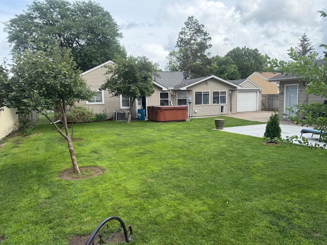 7420 Columbus Ave, Richfield, MN 55423 - view of yard with a hot tub, driveway, and a garage